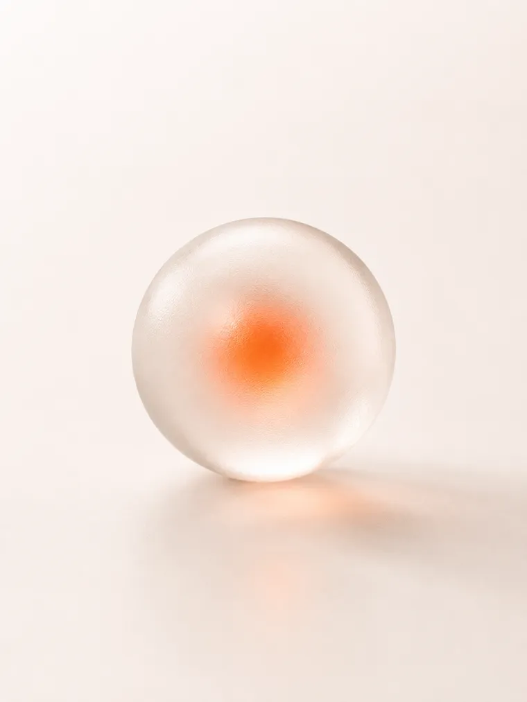 Abstract frosted-glass sphere with a softly glowing orange core